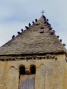 The pigeons in the old bell tower near the cross